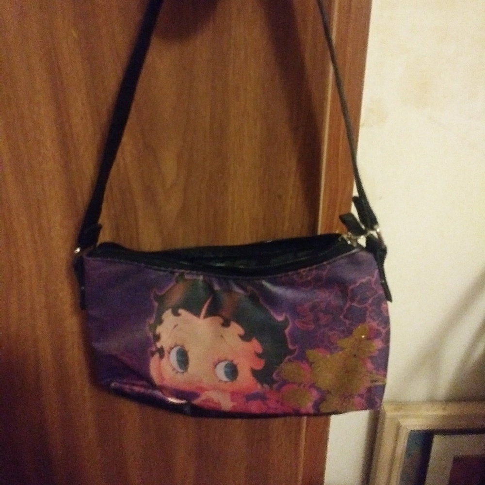 A small hand bag with betty boop on the front
